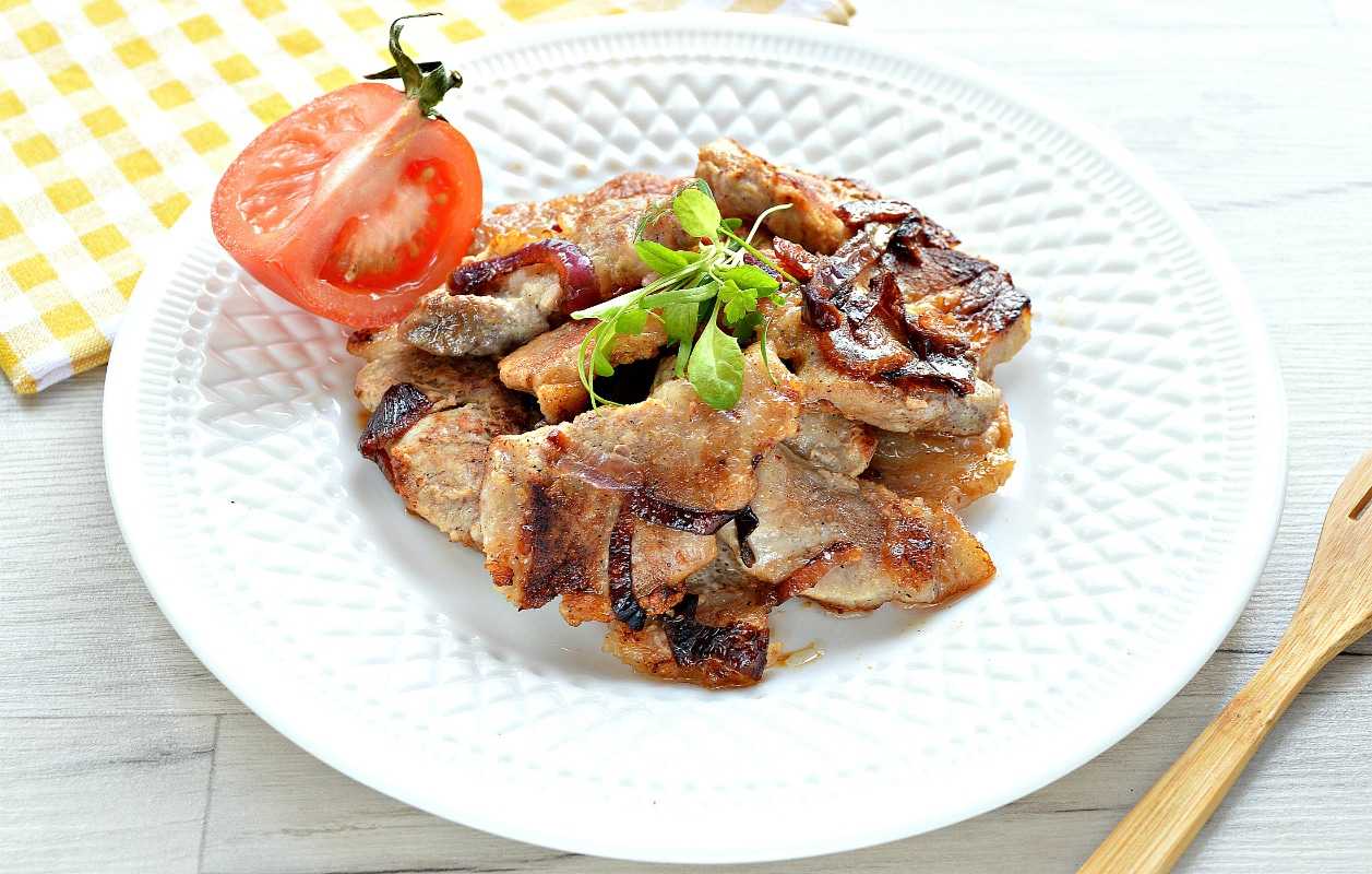 Жареная свинина на сковороде кусочками с луком.